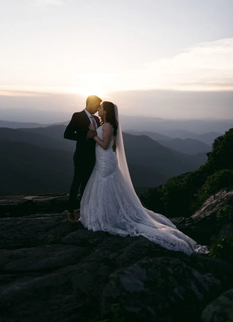 Micro wedding bliss captured by Jennifer Mummert Photography, showcasing a bride and groom sharing a tender moment against a picturesque setting.