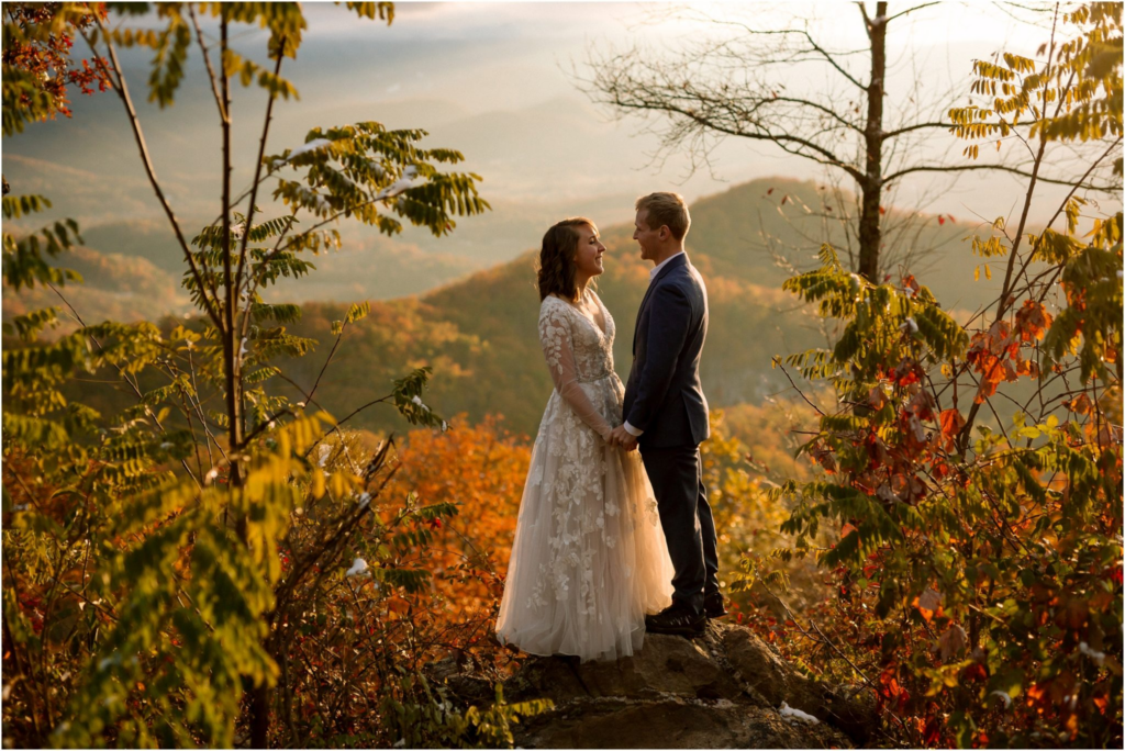 Smoky Mountain Adventure Weddings - Bride & Groom Surrounding by beautiful fall foliage with a mountain view