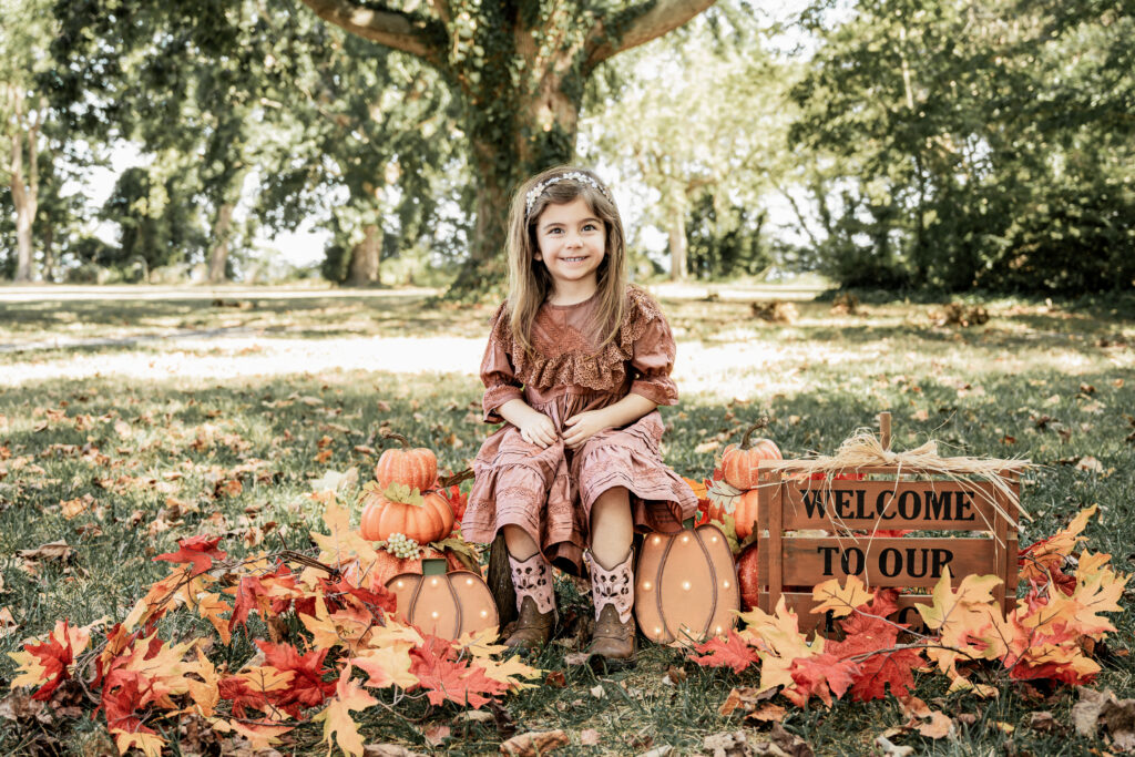 A vibrant fall mini session at Greenwell State Park captured by Jennifer Mummert Photography, featuring the adorable Ms. Evelyn playing in the autumn leaves.