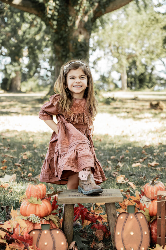 Ms. Evelyn's joyful fall photo shoot amidst the breathtaking scenery of Greenwell State Park, expertly photographed by Jennifer Mummert.