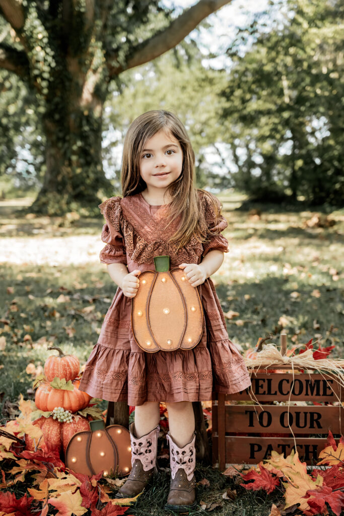 Fall's vibrant hues set the scene for Ms. Evelyn's unforgettable family photos at Greenwell State Park, courtesy of Jennifer Mummert Photography.